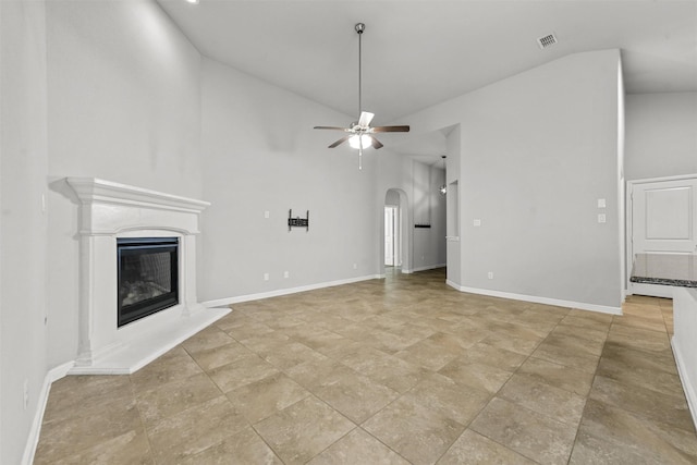 unfurnished living room featuring ceiling fan and high vaulted ceiling