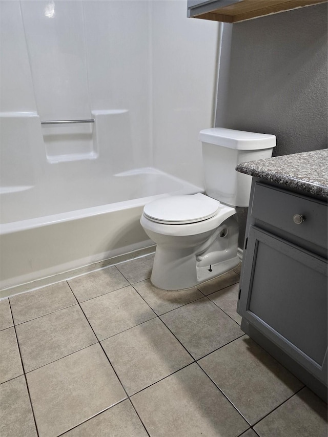 full bathroom with toilet, shower / bathing tub combination, vanity, and tile patterned floors