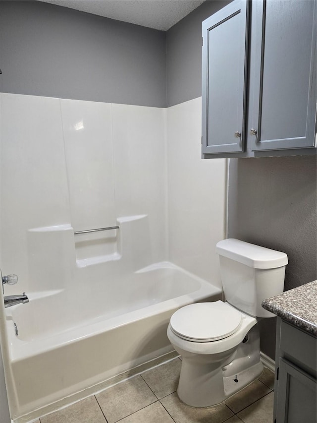 full bathroom with shower / tub combination, tile patterned flooring, vanity, and toilet