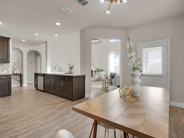 dining room with light hardwood / wood-style floors and sink