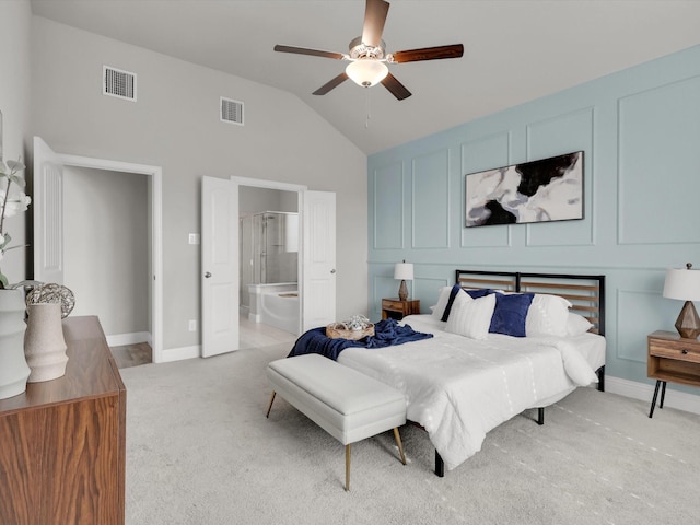 carpeted bedroom with vaulted ceiling, ceiling fan, and connected bathroom