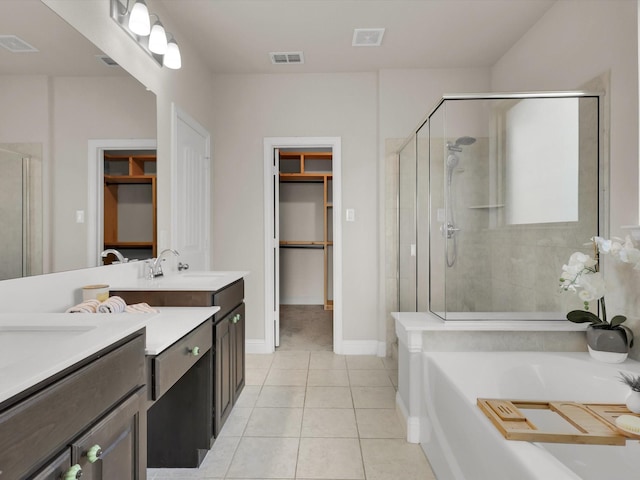 bathroom featuring separate shower and tub, vanity, and tile patterned floors