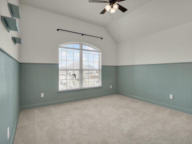 additional living space with ceiling fan, light colored carpet, and lofted ceiling