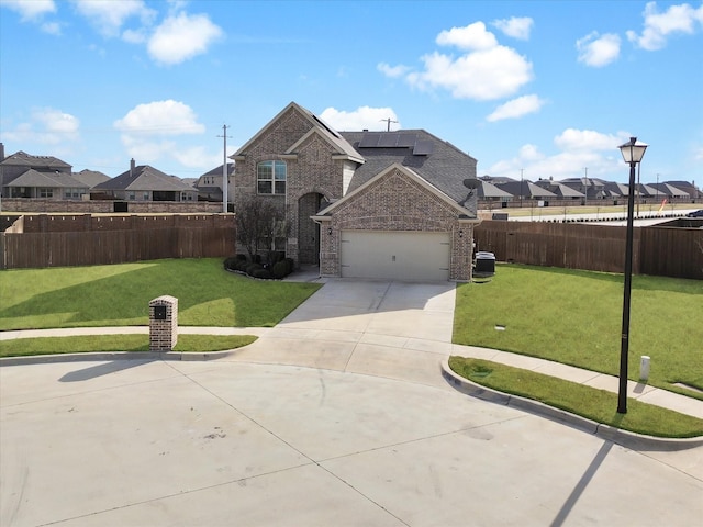 view of front property with a front yard and a garage