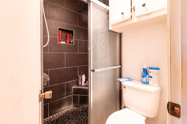 bathroom with tiled shower and toilet