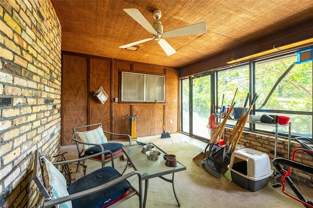 sunroom with ceiling fan and wooden ceiling