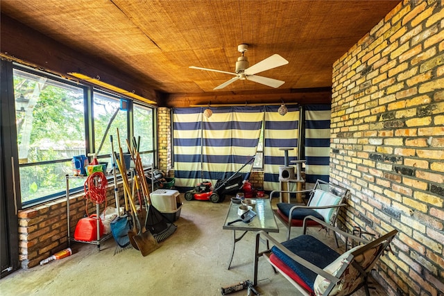 unfurnished sunroom with ceiling fan and wooden ceiling