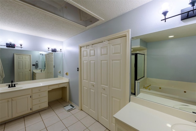 bathroom featuring tile patterned floors, vanity, a textured ceiling, and shower with separate bathtub