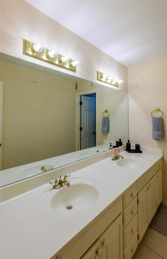 bathroom featuring vanity, a textured ceiling, and tile patterned flooring