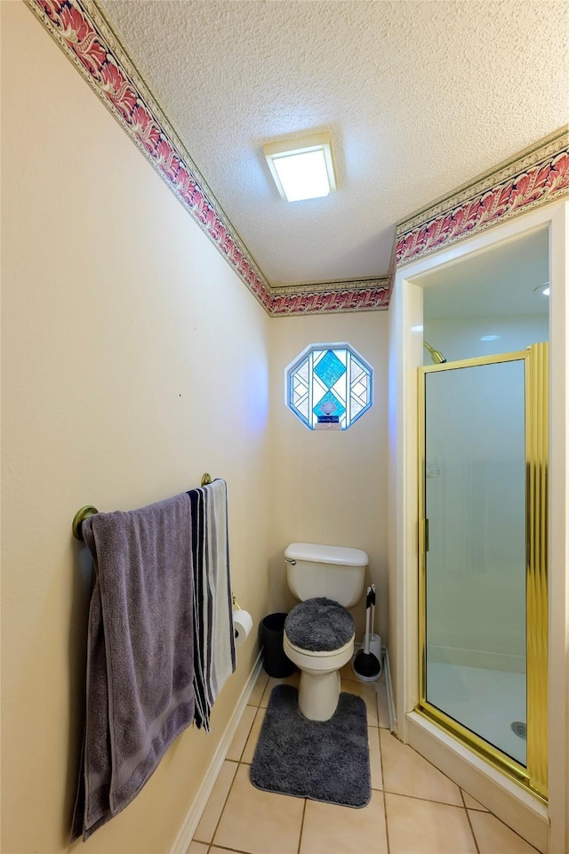 bathroom featuring tile patterned flooring, a shower with shower door, a textured ceiling, and toilet