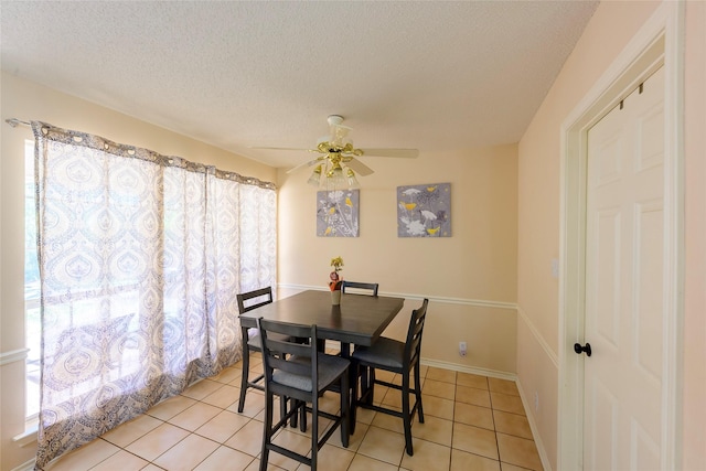 dining room with ceiling fan, light tile patterned floors, and a textured ceiling