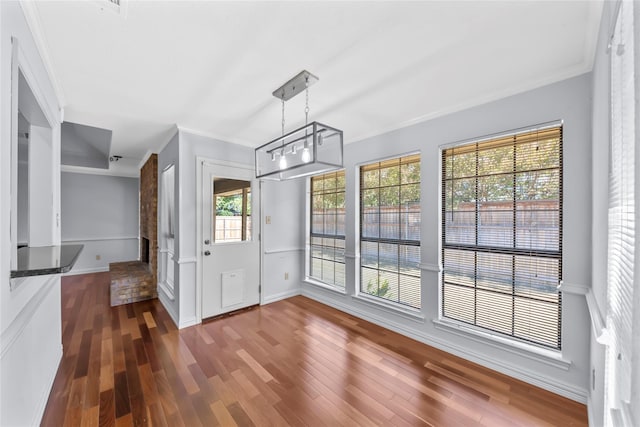 interior space with plenty of natural light, dark hardwood / wood-style flooring, and crown molding