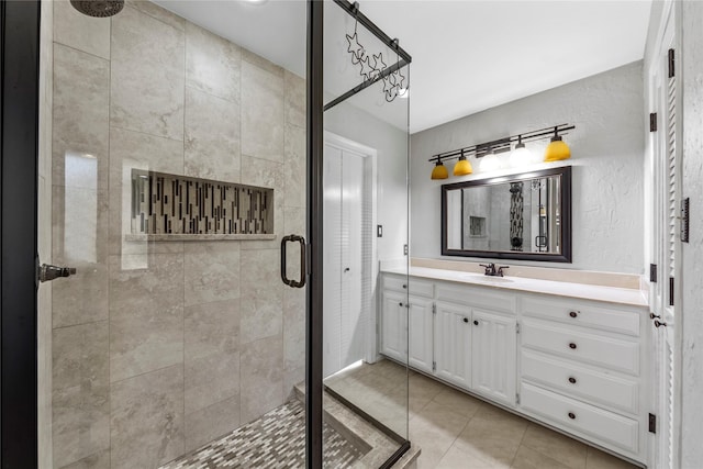 bathroom with tile patterned floors, vanity, and walk in shower