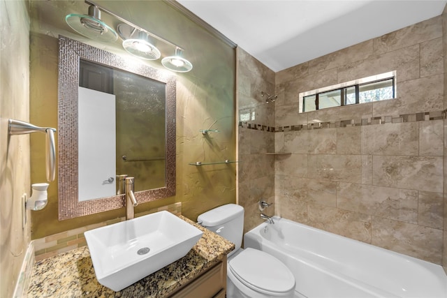 full bathroom with vanity, tile patterned flooring, tiled shower / bath, and toilet