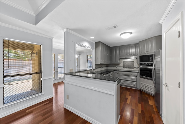 kitchen featuring kitchen peninsula, ornamental molding, gray cabinets, oven, and stainless steel refrigerator