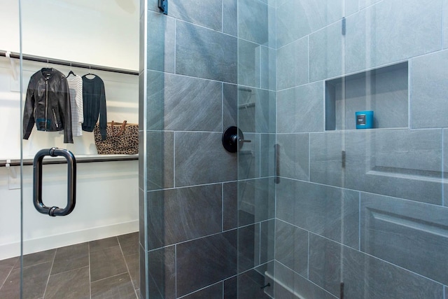 bathroom with tile patterned floors and a shower with shower door