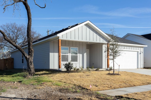 view of front facade featuring solar panels and a garage