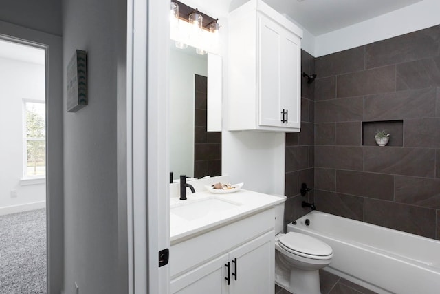 full bathroom featuring tile patterned floors, vanity, tiled shower / bath combo, and toilet