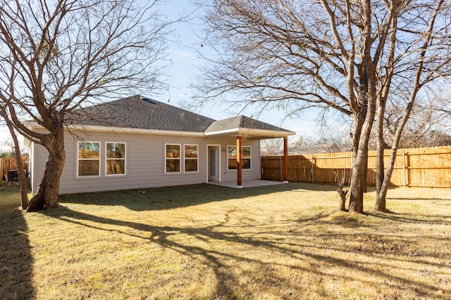 back of property with a patio area and a yard