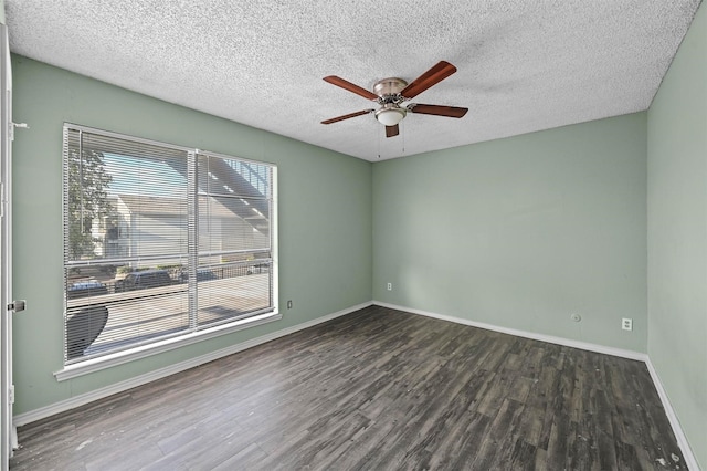 empty room featuring a textured ceiling, ceiling fan, and dark wood-type flooring