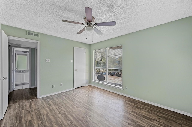 unfurnished bedroom with a closet, a textured ceiling, hardwood / wood-style flooring, and ceiling fan