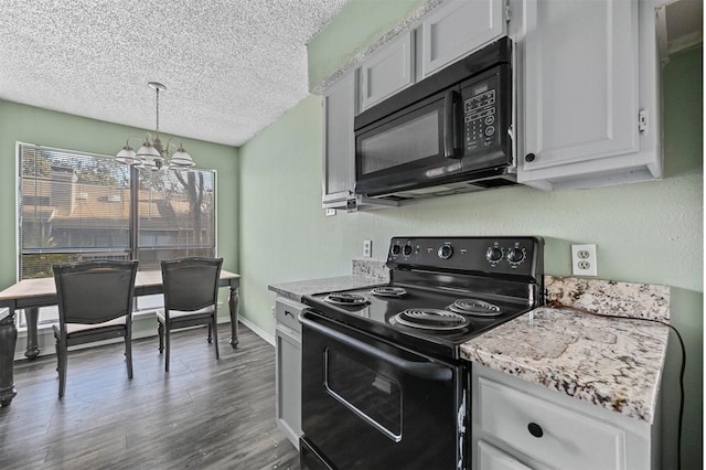 kitchen with hanging light fixtures, black appliances, white cabinets, a chandelier, and dark hardwood / wood-style floors