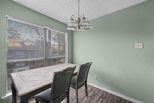 dining space featuring hardwood / wood-style floors, a textured ceiling, and a notable chandelier