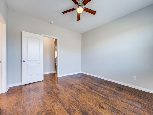 unfurnished room with ceiling fan and dark wood-type flooring