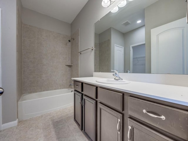 bathroom with vanity and tiled shower / bath combo