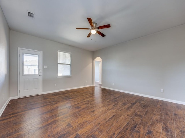 empty room with ceiling fan and dark hardwood / wood-style floors