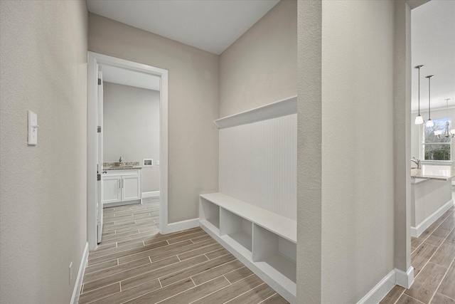 mudroom with a chandelier