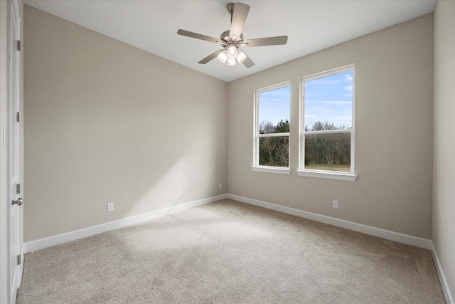 carpeted spare room with ceiling fan