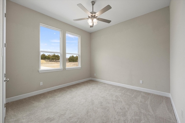 empty room featuring ceiling fan and light colored carpet