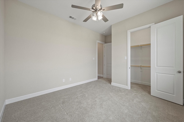 unfurnished bedroom with ceiling fan, light colored carpet, and a closet