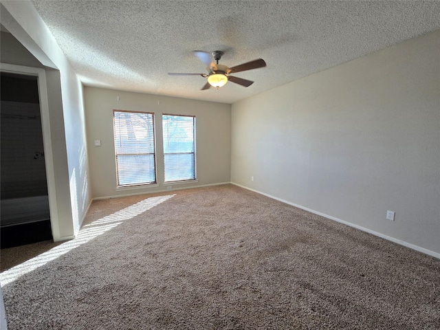 carpeted empty room featuring a textured ceiling and ceiling fan