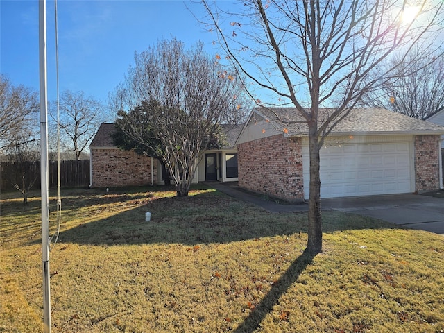 single story home featuring a front yard and a garage