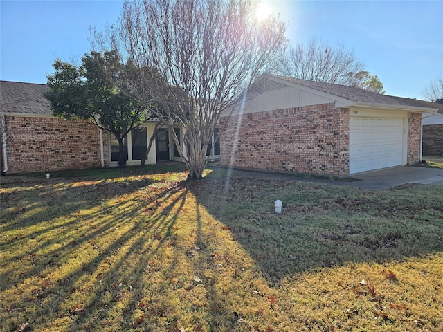 ranch-style home with a front lawn and a garage