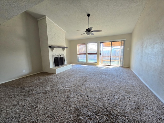 unfurnished living room featuring ceiling fan, a brick fireplace, a textured ceiling, and carpet flooring