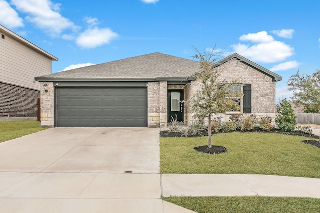 view of front of house featuring a garage and a front yard