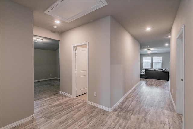 corridor with light hardwood / wood-style floors