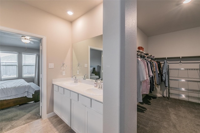 bathroom featuring tile patterned flooring, vanity, and ceiling fan