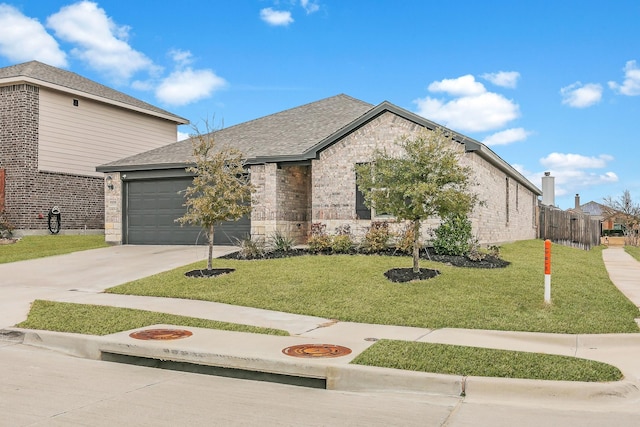 view of front facade featuring a garage and a front yard