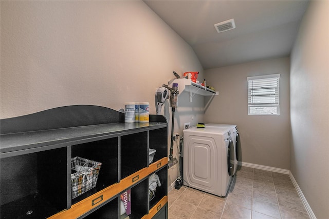 washroom featuring separate washer and dryer and light tile patterned floors