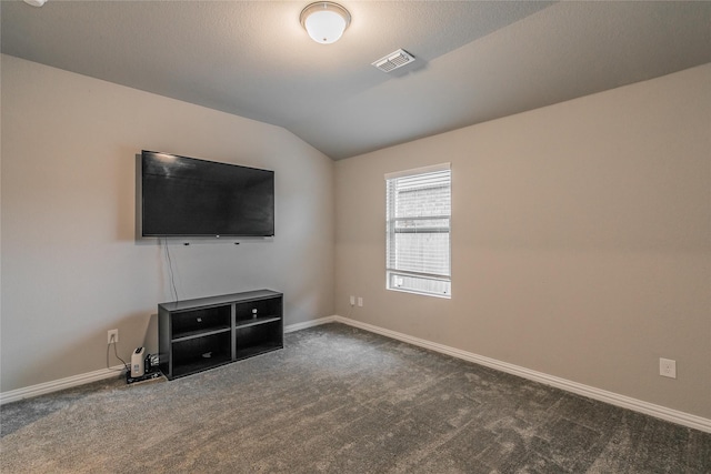 unfurnished living room with dark carpet and vaulted ceiling