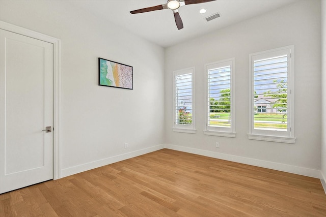 unfurnished room with ceiling fan, light hardwood / wood-style floors, and plenty of natural light