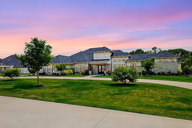 french country home featuring a yard