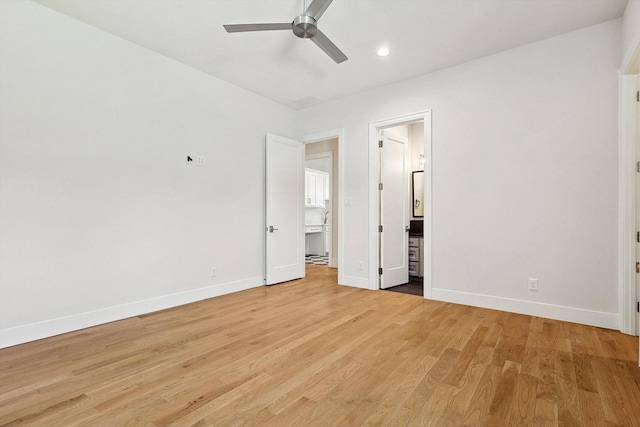 unfurnished bedroom featuring connected bathroom, ceiling fan, and light hardwood / wood-style flooring