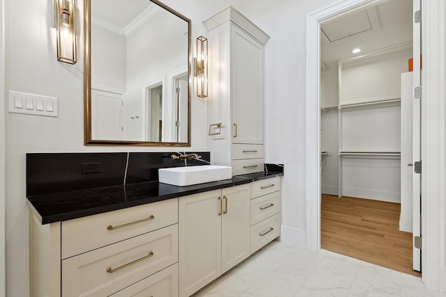 bathroom featuring ornamental molding, backsplash, and vanity