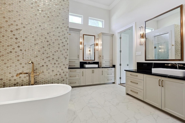 bathroom featuring a towering ceiling, a bathing tub, and vanity