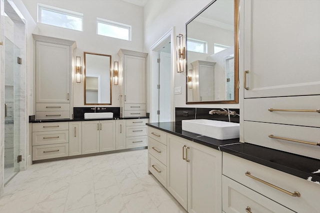 bathroom with ornamental molding, plenty of natural light, vanity, and a shower with shower door